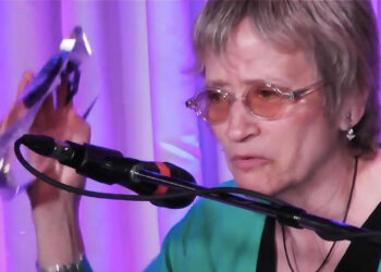 Jane Ira Bloom holding JJA Jazz Award at microphone