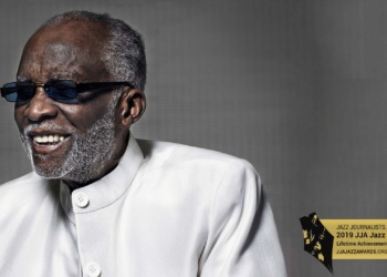 Ahmad Jamal with sunglasses and white suite