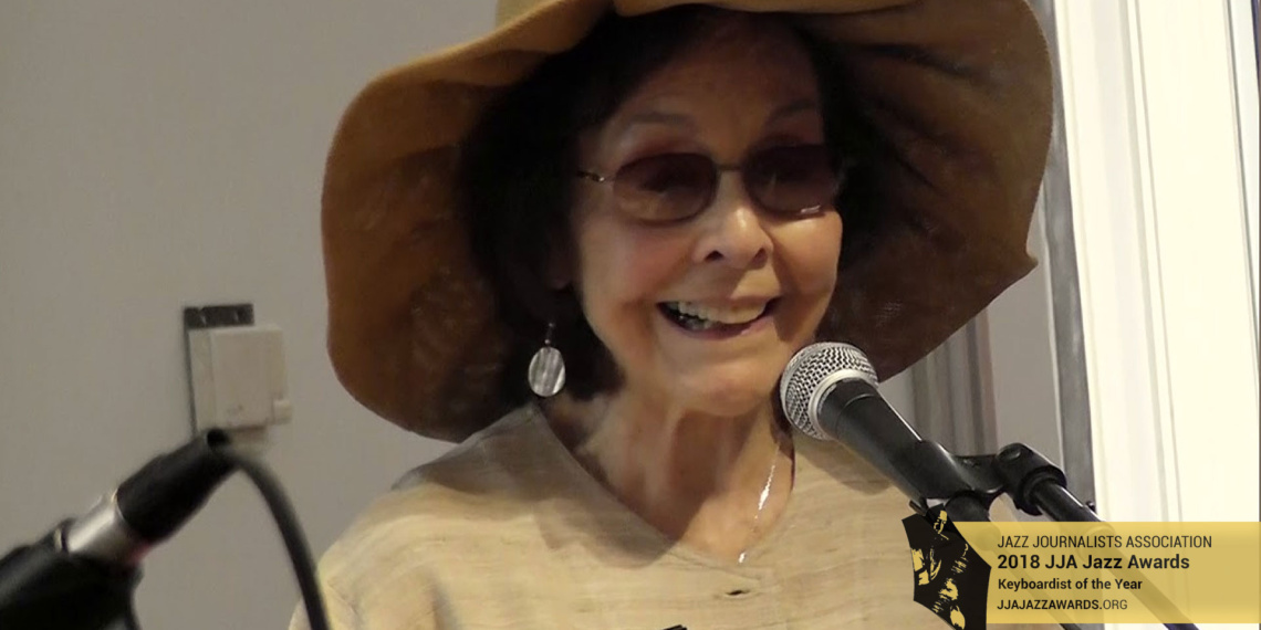 Patricia Willard speaking at a podium