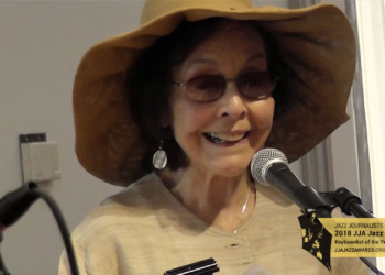 Patricia Willard speaking at a podium